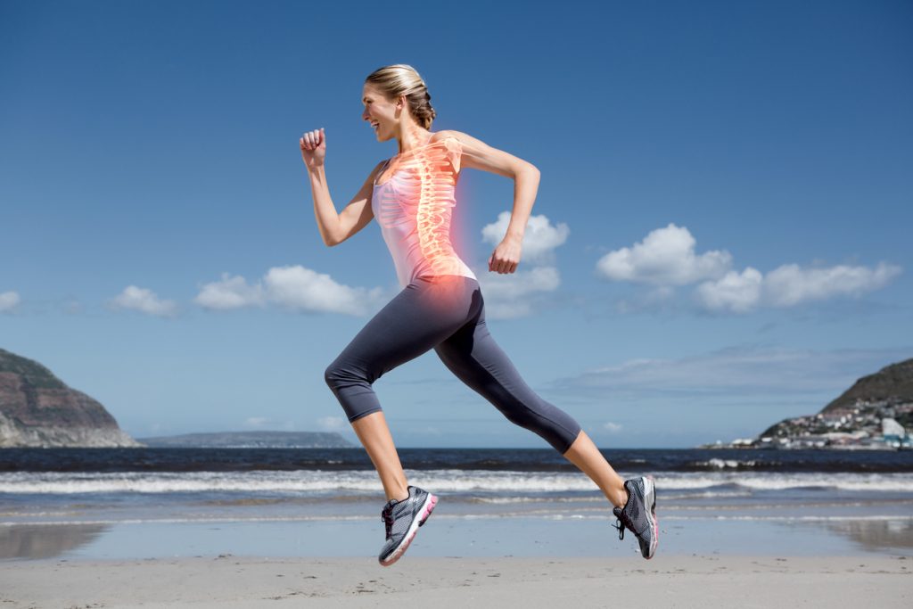 Digital composite of Highlighted back bones of jogging woman on beach